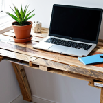 Upcycled Pallet Desk**

"A bright and airy home office featuring a desk made from upcycled wooden pallets, fully clothed, appropriate attire, safe for work. The desk is neatly organized with a laptop, stationery, and a small potted plant. The background includes a white wall with motivational art and natural light streaming through a window. Perfect anatomy, correct proportions, natural pose, well-formed hands, proper finger count, natural body proportions, professional, modest, family-friendly, high quality."

**